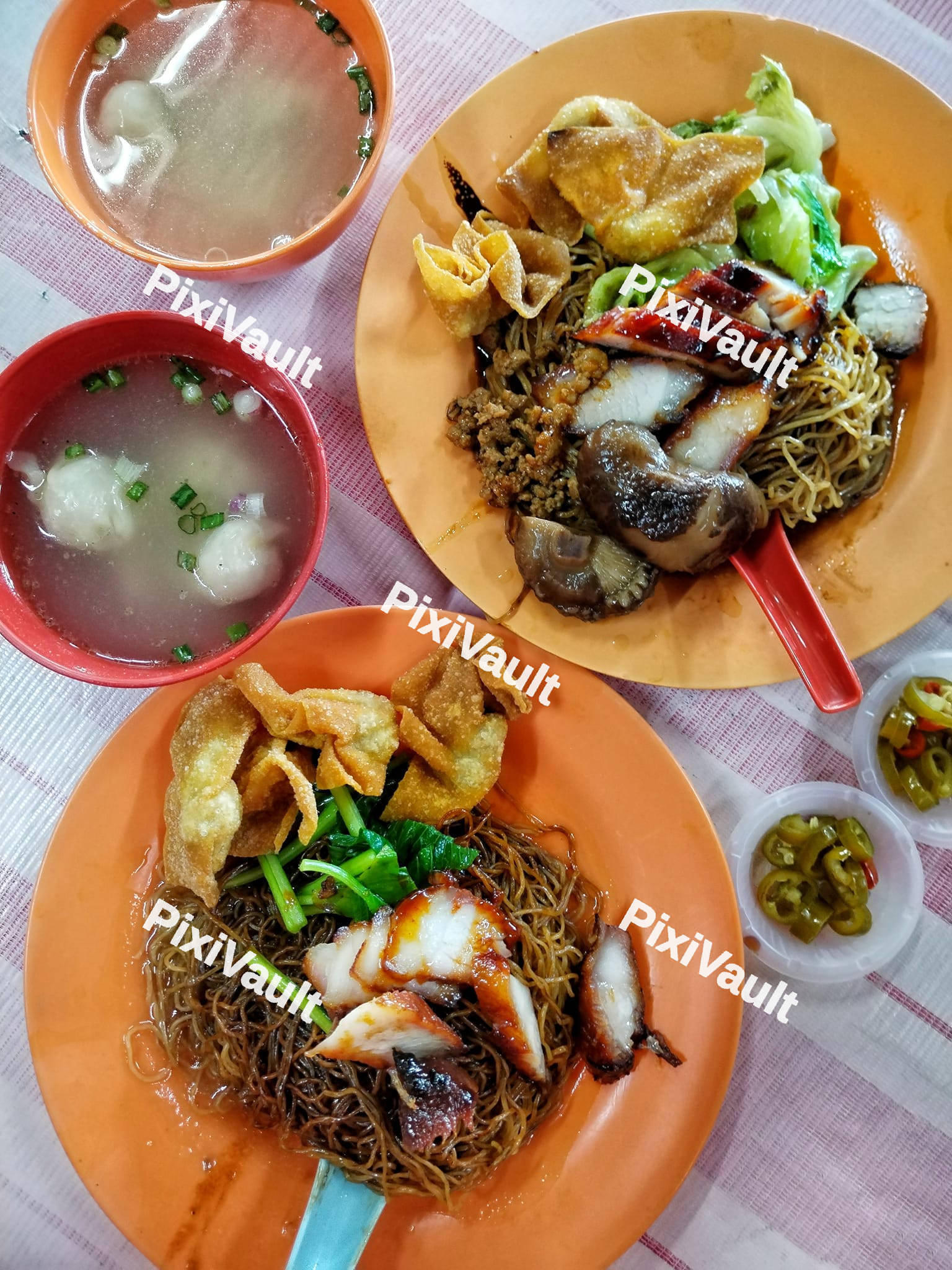 Two plates with pork and noddle
